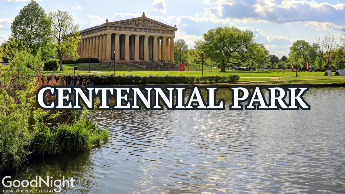 This exterior image features the Parthenon structure in Centennial Park, surrounded by serene water and lush greenery. Visitors can be seen enjoying outdoor activities such as picnicking, walking, and exploring the historic site. The scene captures both the grandeur of the park's iconic landmark and the inviting atmosphere of the green space.