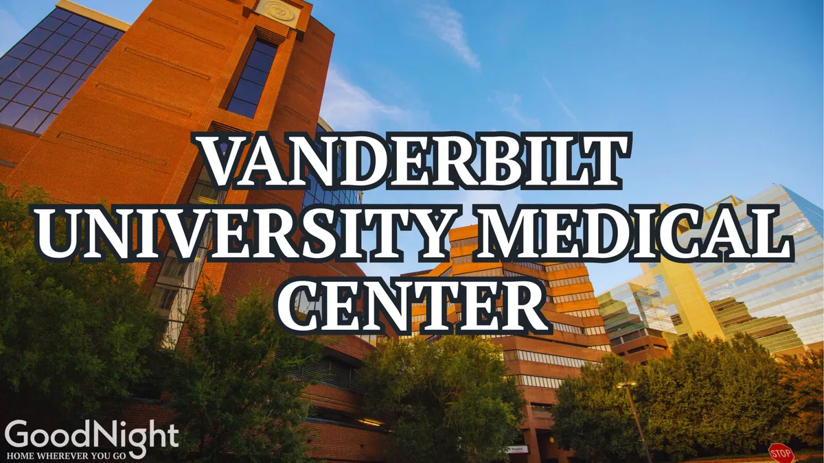 The exterior of Vanderbilt University Medical Center, surrounded by greenery and set against the Nashville skyline. The prominent building entrance reflects the area's reputation for world-class healthcare and medical services.