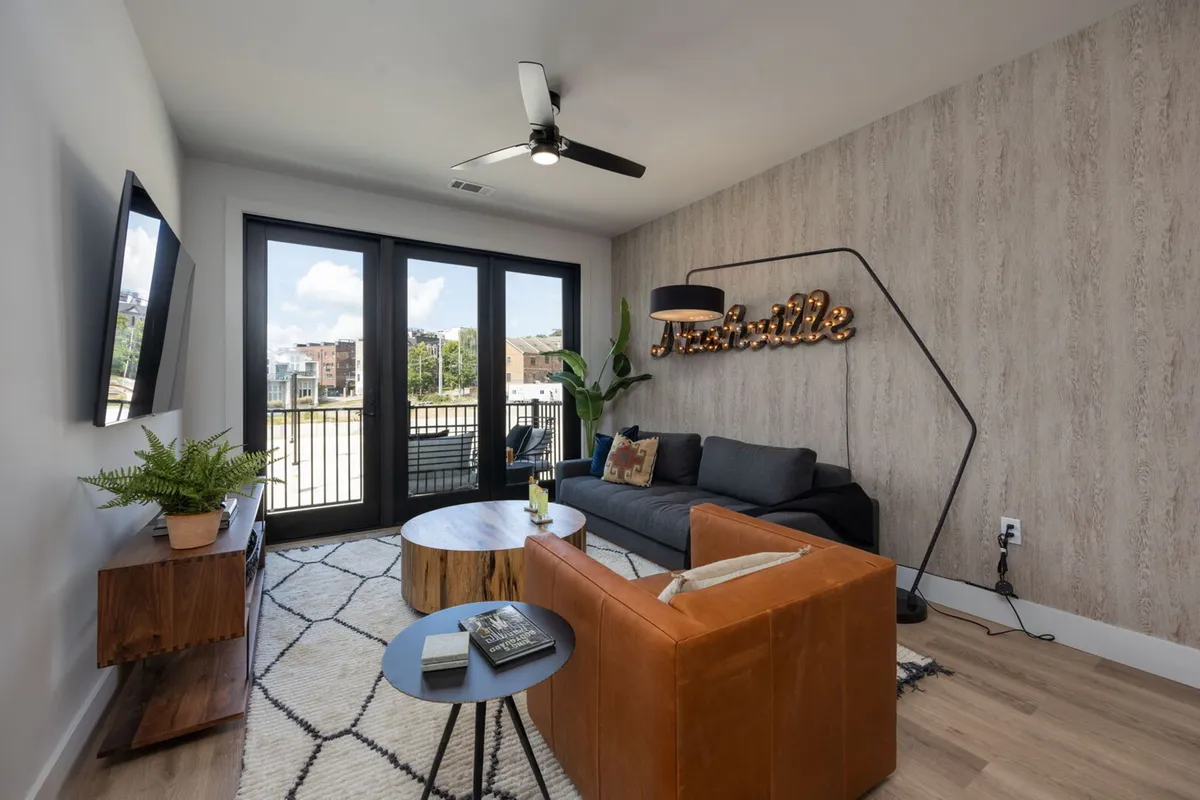 A cozy living area with a plush sofa, coffee table, decorative lighting, and stylish wall decor. This flexible space is ideal for relaxing or socializing, and can accommodate additional sleeping with a sleeper sofa.
